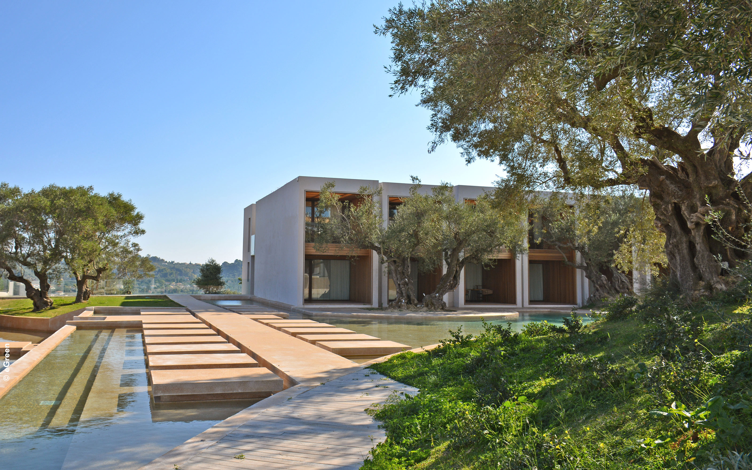 Hotel complex with water basins and olive trees